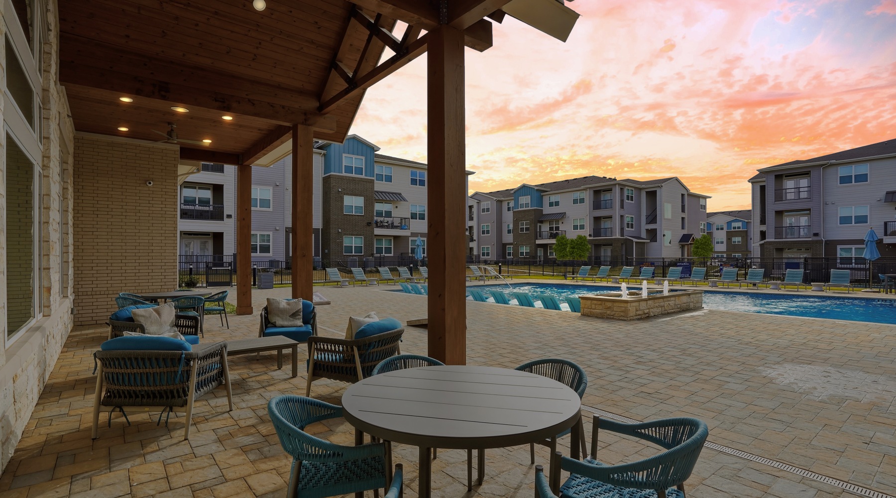 pool view with chairs, covered patio, tables and pool view with sunset